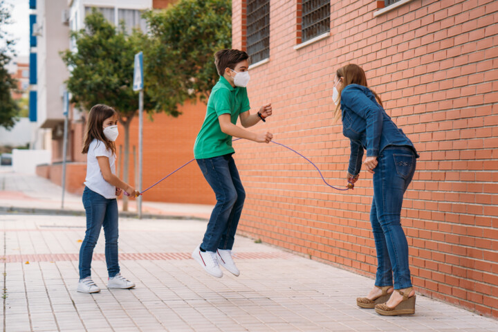 Kids jumping rope with masks on
