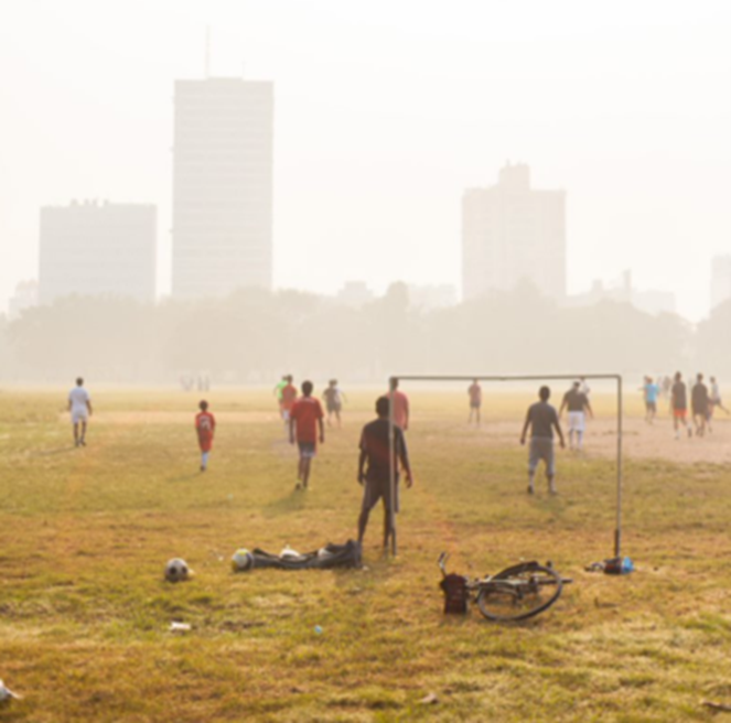 Outdoor soccer on a field when there’s low air quality and smog is visible.
