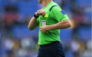 Referee putting away a card. 