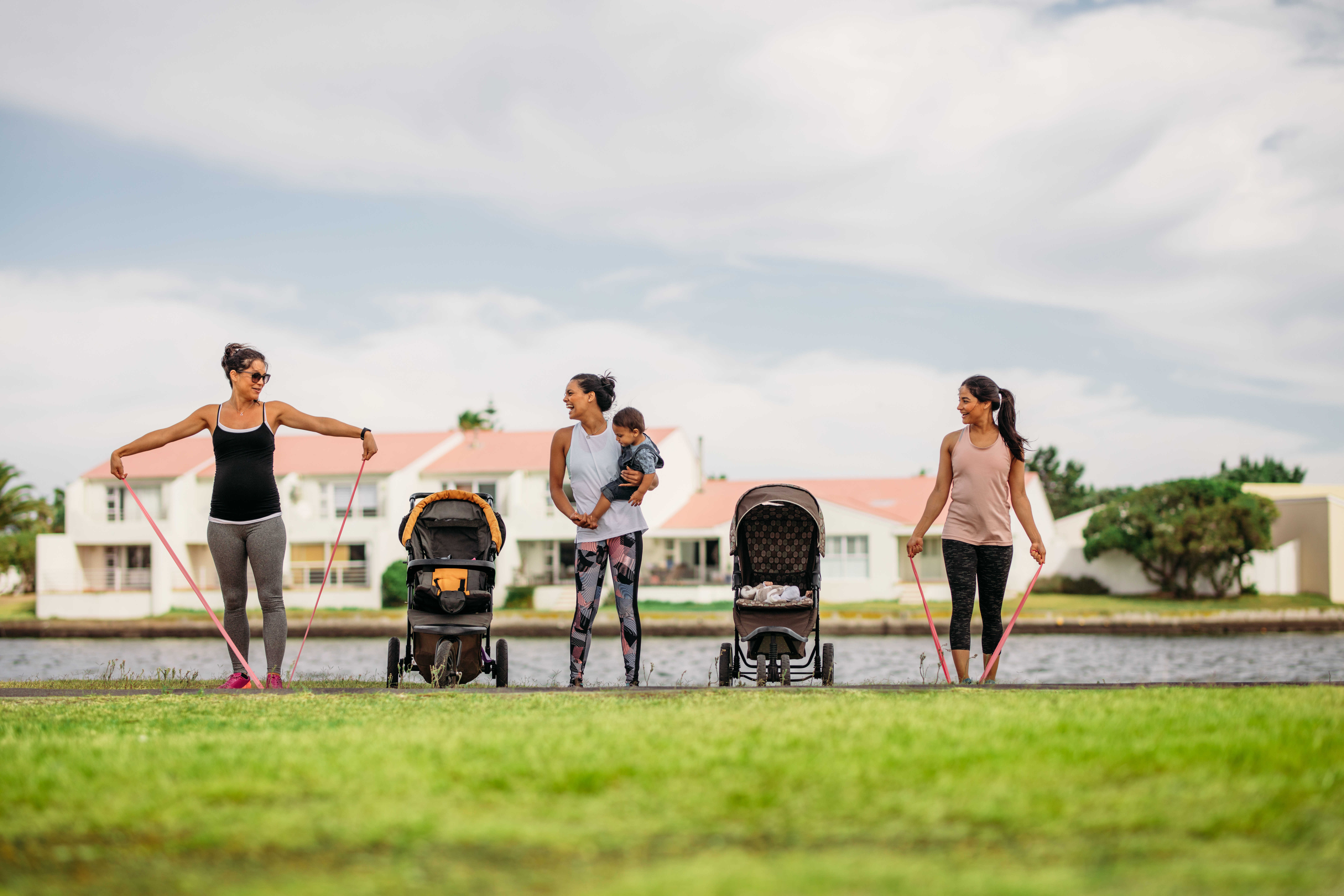 Mothers with strollers work out in the park