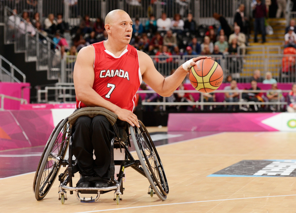 Richard Peter playing wheelchair basketball in a Team Canada jersey.