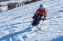 Athlete with a disability skiing down a mountain