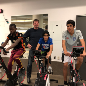 children on spin bikes at Winnipeg Newcomer Sport Academy