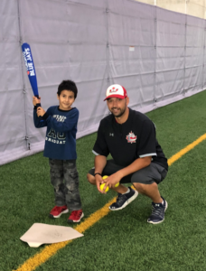 Child with baseball bat at Winnipeg Newcomer Sport Academy